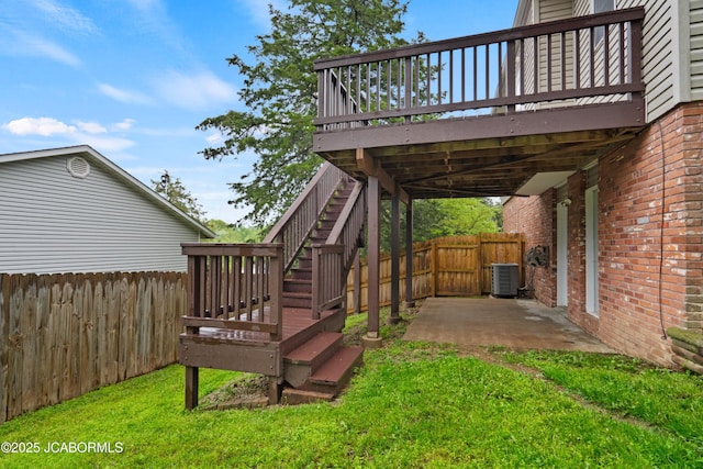 view of yard featuring central air condition unit, a fenced backyard, and a deck