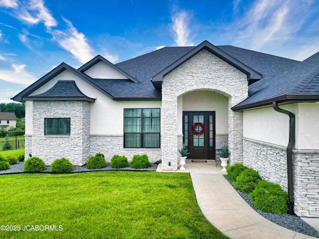 5621 Lightpost Dr, Columbia, MO 65201 - view of front of home with stone siding, stucco siding, a front yard, and a shingled roof