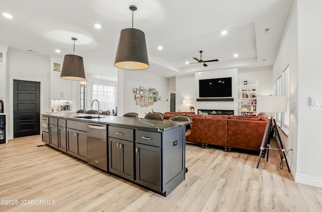 5621 Lightpost Dr, Columbia, MO 65201 - kitchen with dishwasher, light wood-style flooring, a ceiling fan, white cabinetry, and recessed lighting