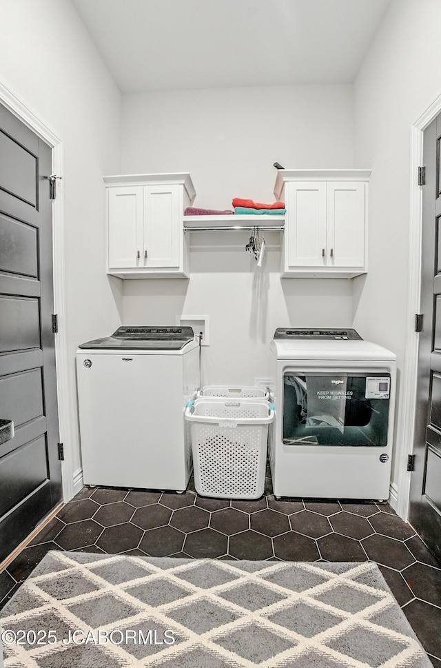 5621 Lightpost Dr, Columbia, MO 65201 - washroom featuring cabinet space, washer and clothes dryer, and dark tile patterned flooring