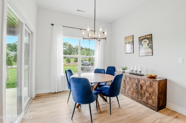 5621 Lightpost Dr, Columbia, MO 65201 - dining space featuring light wood-style flooring and a chandelier
