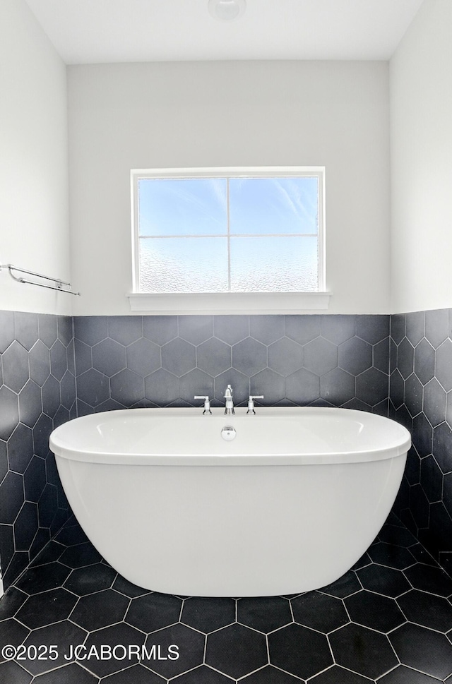 5621 Lightpost Dr, Columbia, MO 65201 - full bathroom with healthy amount of natural light, tile walls, a soaking tub, wainscoting, and tile patterned flooring