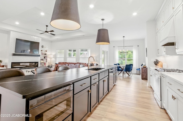 5621 Lightpost Dr, Columbia, MO 65201 - kitchen with stainless steel appliances, light wood-type flooring, open floor plan, white cabinetry, and recessed lighting