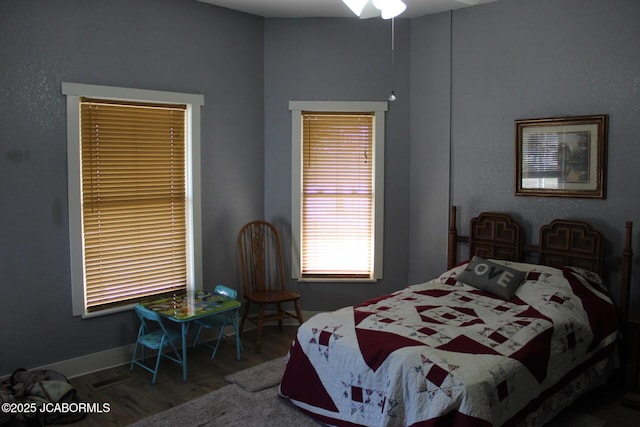 bedroom featuring baseboards and wood finished floors