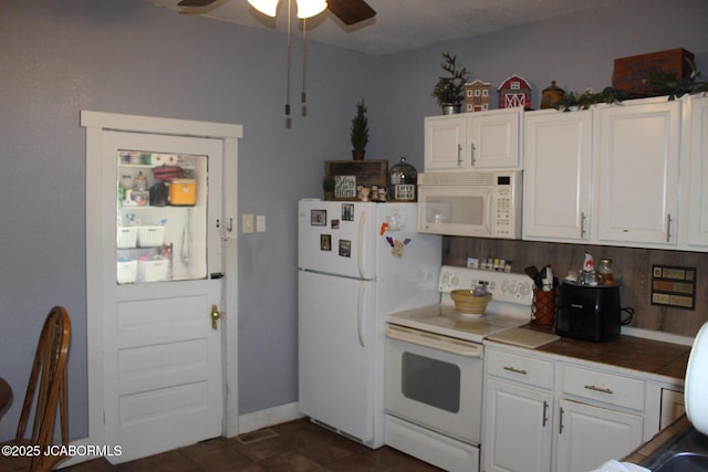 kitchen with white appliances, white cabinets, tile counters, and ceiling fan