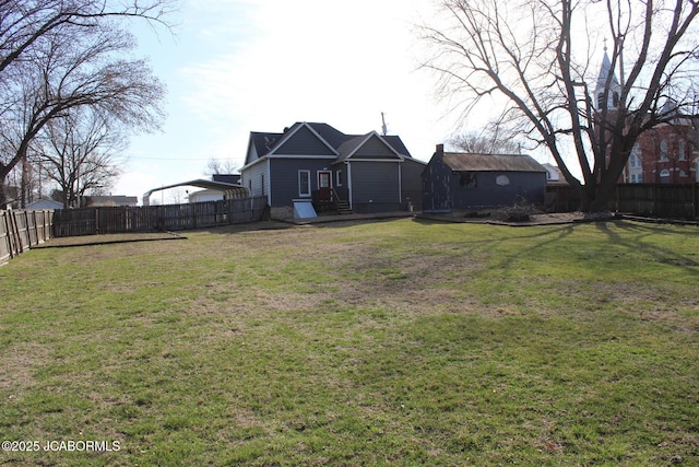 view of yard featuring a carport and a fenced backyard