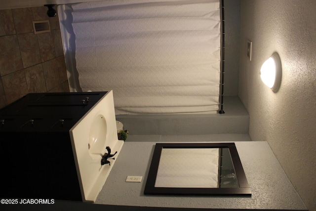 bathroom featuring a textured wall