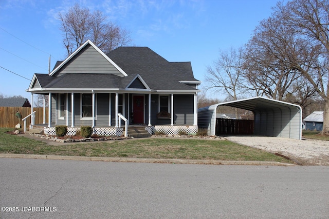 view of front of house with a detached carport, fence, roof with shingles, covered porch, and driveway