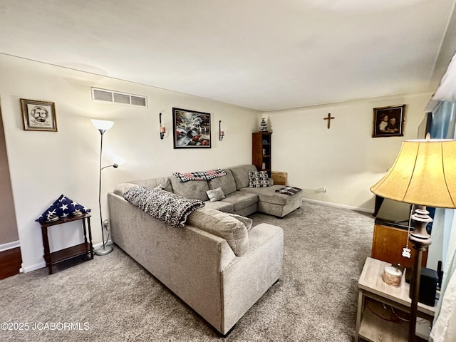 living area with visible vents, baseboards, and carpet flooring