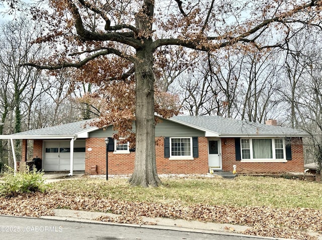 ranch-style house featuring brick siding, a shingled roof, a front yard, a chimney, and a garage