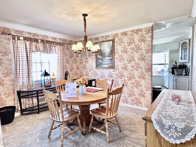 dining space with wallpapered walls, a chandelier, a wealth of natural light, and light carpet