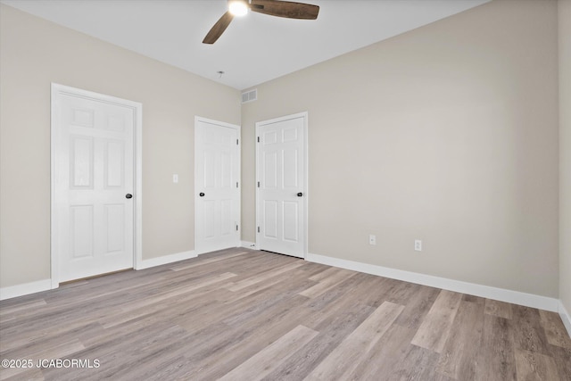 unfurnished bedroom featuring light wood-type flooring, visible vents, and baseboards