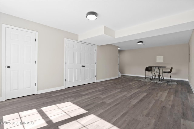 interior space with wood finished floors and baseboards