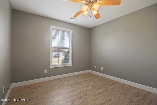 spare room with light hardwood / wood-style floors and ceiling fan