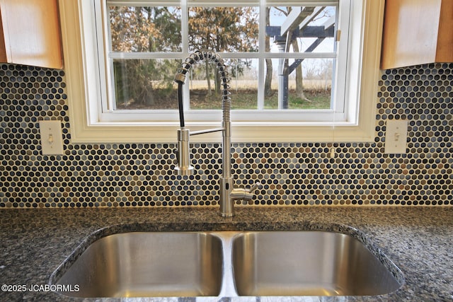 interior details featuring sink and dark stone counters