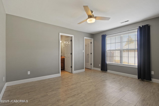 unfurnished bedroom with connected bathroom and ceiling fan