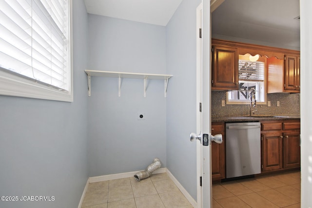 laundry area with light tile patterned flooring and electric dryer hookup