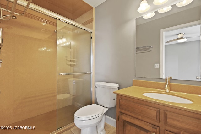 bathroom featuring walk in shower, vanity, toilet, and tile patterned flooring