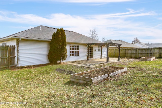 rear view of property with a yard, a pergola, and a patio area