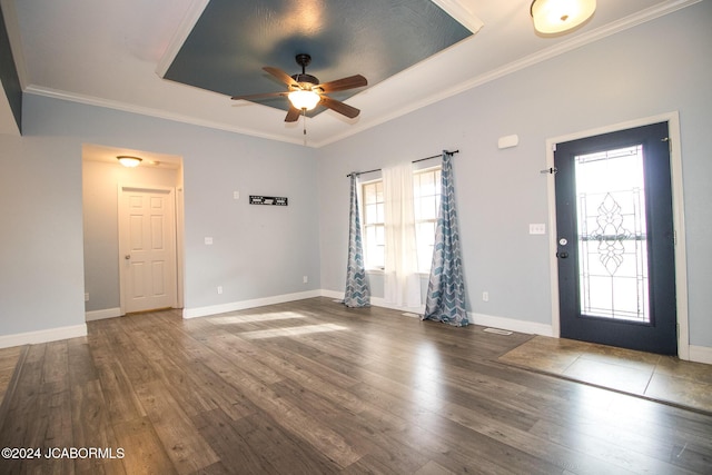 entryway with ceiling fan, ornamental molding, and dark wood-type flooring