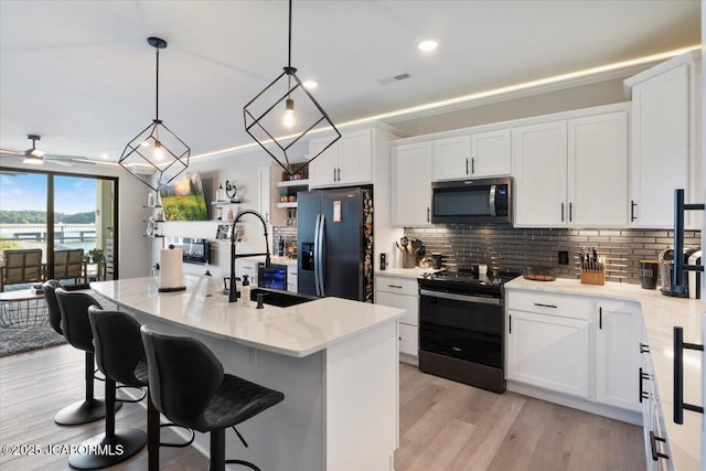 1055 Topsider Ln Unit 212, Osage Beach, MO 65065 - kitchen with electric stove, stainless steel microwave, fridge with ice dispenser, tasteful backsplash, and recessed lighting