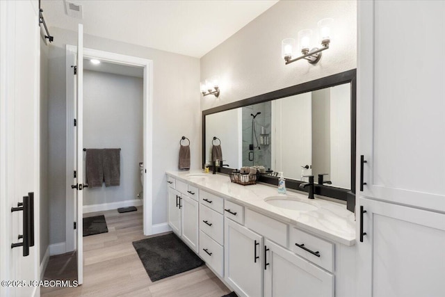 1055 Topsider Ln Unit 212, Osage Beach, MO 65065 - full bath with double vanity, a walk in shower, and wood finished floors