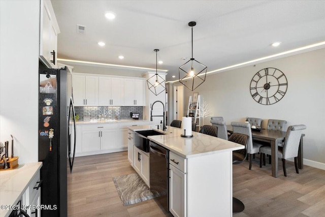 1055 Topsider Ln Unit 212, Osage Beach, MO 65065 - kitchen with freestanding refrigerator, dishwashing machine, white cabinets, decorative backsplash, and light wood-style floors
