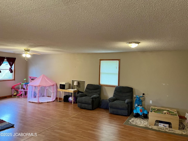 508 S Poplar St, Chamois, MO 65024 - playroom with healthy amount of natural light, wood finished floors, a textured ceiling, and a ceiling fan