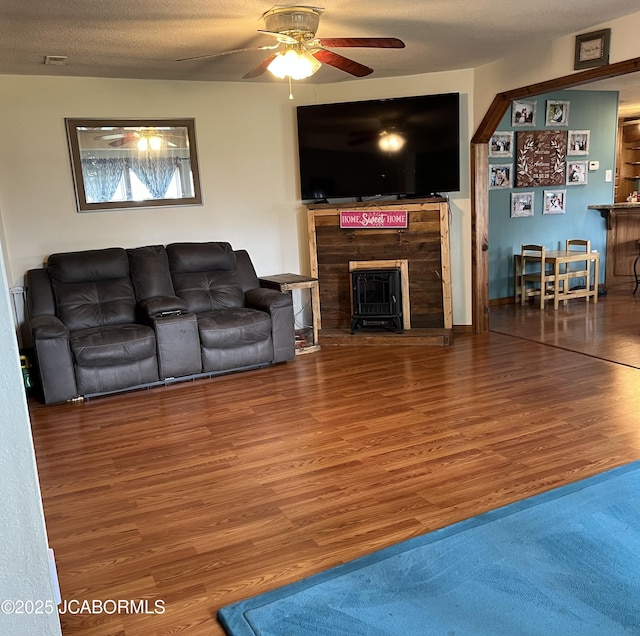 508 S Poplar St, Chamois, MO 65024 - living area featuring wood finished floors, ceiling fan, and a fireplace with raised hearth