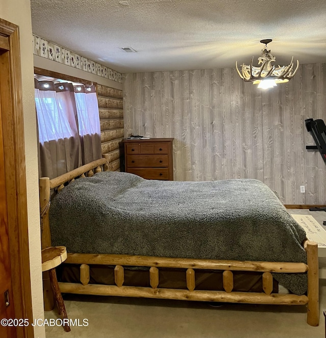 508 S Poplar St, Chamois, MO 65024 - bedroom with a chandelier, a textured ceiling, and rustic walls