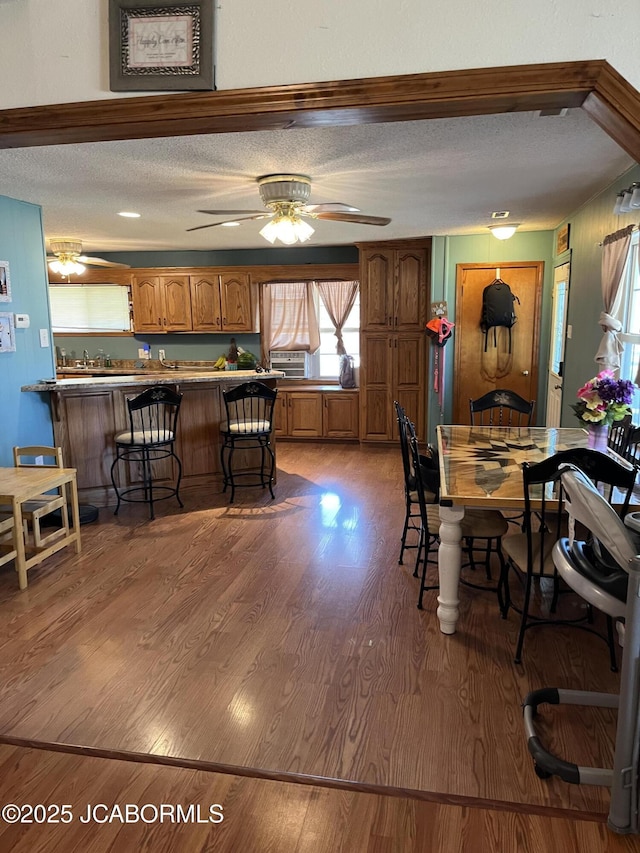 508 S Poplar St, Chamois, MO 65024 - dining area featuring a textured ceiling, ceiling fan, and wood finished floors