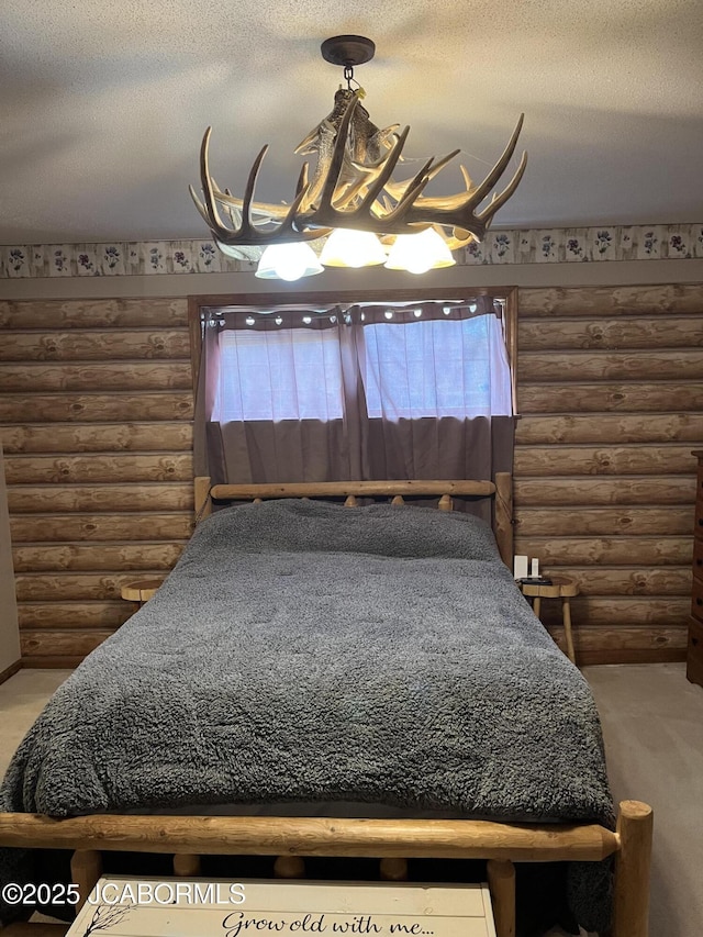 508 S Poplar St, Chamois, MO 65024 - carpeted bedroom featuring log walls and a textured ceiling