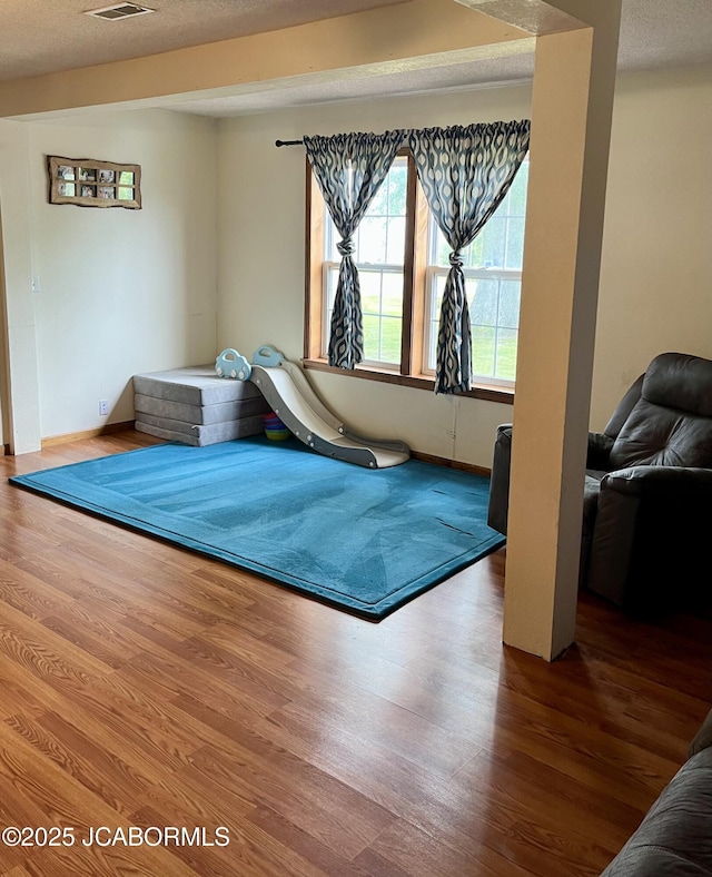 508 S Poplar St, Chamois, MO 65024 - bedroom featuring wood finished floors and a textured ceiling