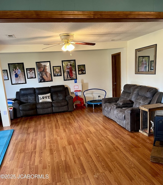 508 S Poplar St, Chamois, MO 65024 - living area featuring a ceiling fan, light wood-type flooring, and a textured ceiling