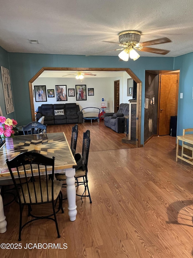 508 S Poplar St, Chamois, MO 65024 - dining room featuring a ceiling fan, wood finished floors, and a textured ceiling