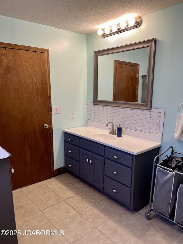 508 S Poplar St, Chamois, MO 65024 - bathroom with vanity, backsplash, tile patterned flooring, and a textured ceiling