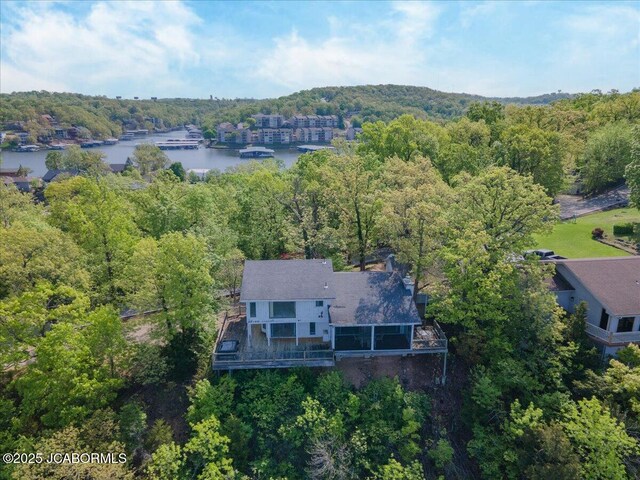 drone / aerial view with a water view and a view of trees