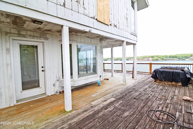 wooden terrace featuring a water view
