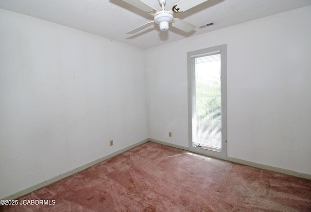 unfurnished room with visible vents, baseboards, ceiling fan, and light carpet