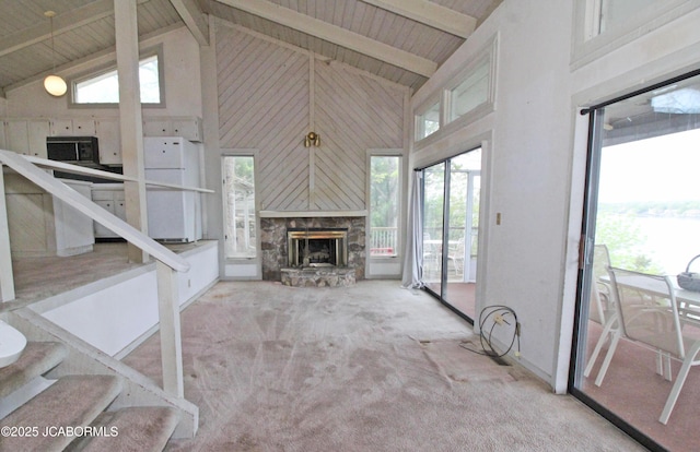 unfurnished living room with carpet, a fireplace, high vaulted ceiling, and wooden ceiling