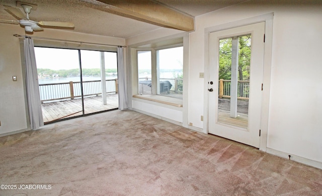 unfurnished sunroom featuring a water view