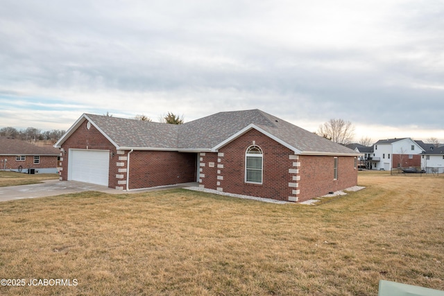 view of front of house with brick siding, a shingled roof, a front yard, a garage, and driveway