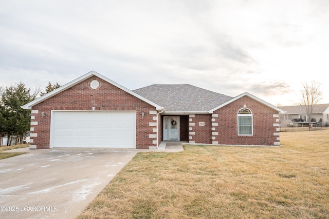 view of front facade with brick siding, a shingled roof, a front lawn, a garage, and driveway