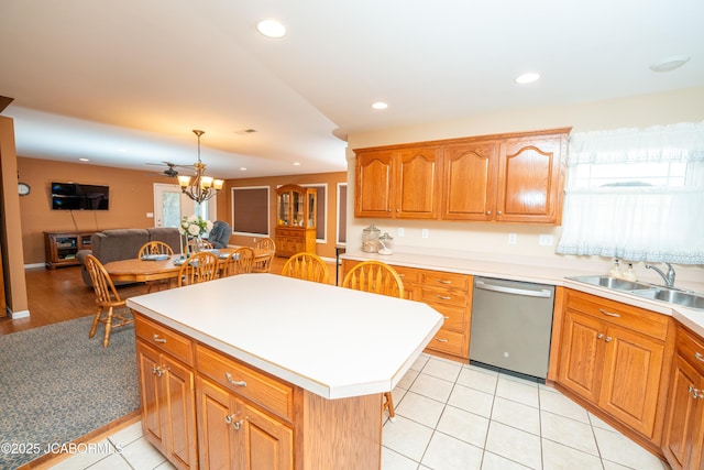 kitchen featuring a sink, dishwasher, recessed lighting, and light countertops