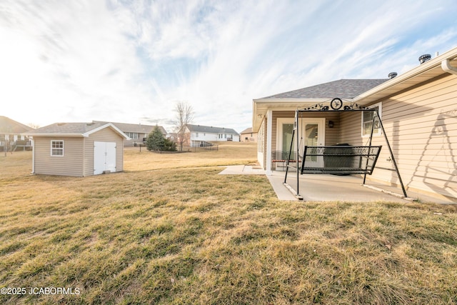 view of yard with a patio area, a storage shed, and an outdoor structure