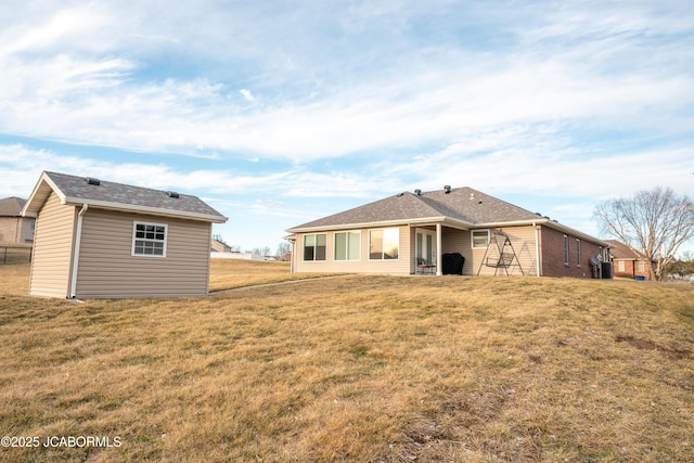 rear view of property featuring a yard