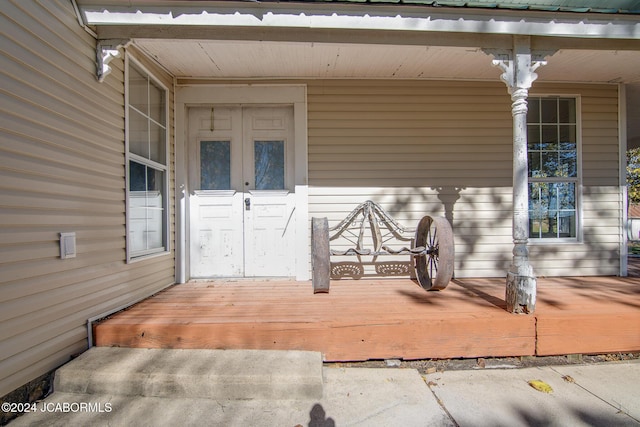 view of exterior entry with covered porch