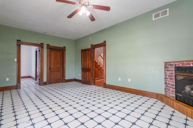 interior space with ceiling fan and a fireplace