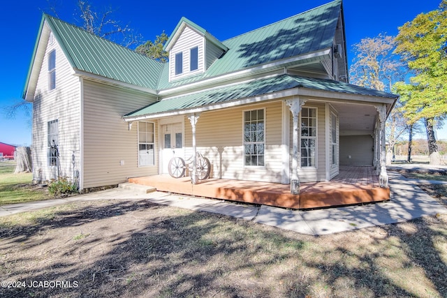 rear view of house with covered porch