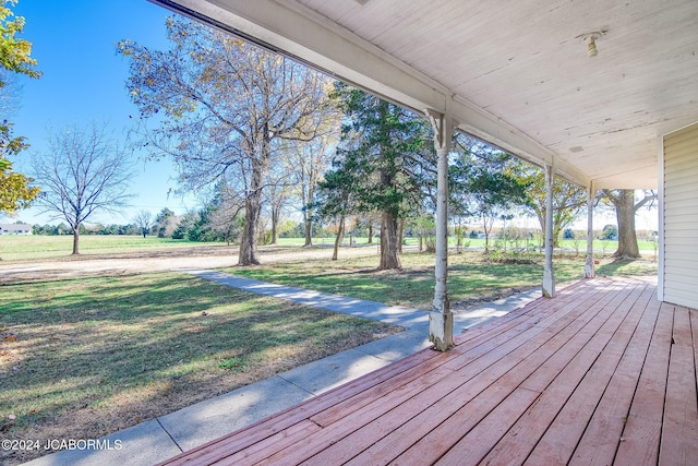 wooden deck with covered porch and a yard